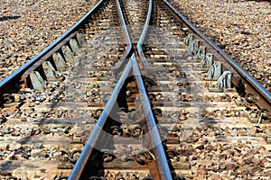 Two railway tracks converge into one track photo