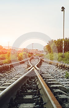 Two railways tracks merge close up.Vintage tone. Vertical photography