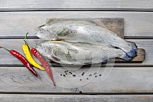 Two rainbow trouts on rustic wooden table