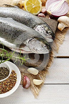 Two rainbow trouts on rustic wooden table