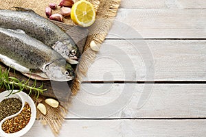 Two rainbow trouts on rustic wooden table
