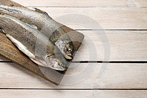 Two rainbow trouts on rustic wooden table