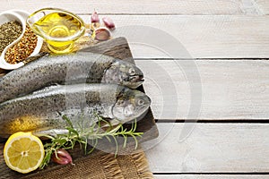 Two rainbow trouts on rustic wooden table