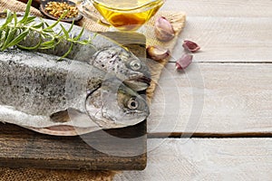 Two rainbow trouts on rustic wooden table
