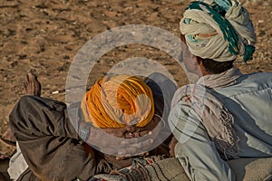 Two Rajasthani tribal men wearing traditional turbans attend the annual Pushkar Cattle Fair