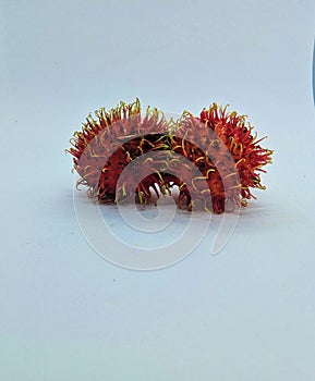 two rambutans or known as hairy fruit on a white background