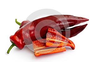 Two Ramiro sweet pointed peppers isolated on white and two cut p