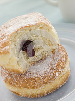 Two Raspberry Jam Doughnuts with a bite