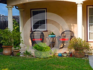 Two rattan  chairs in the front porch