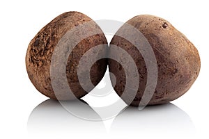 Two raw beets on a white background