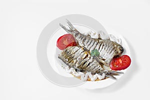 Two raw fish on a white plate
