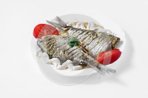 Two raw fish on a white plate