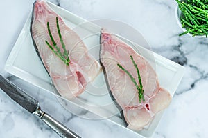Two raw halibut steaks