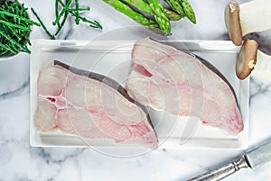 Two raw halibut steaks