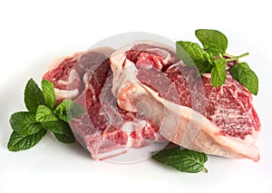 Two raw lamb chops over white