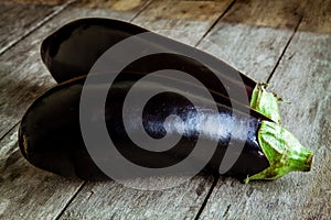 Two raw organic eggplant on old wooden background