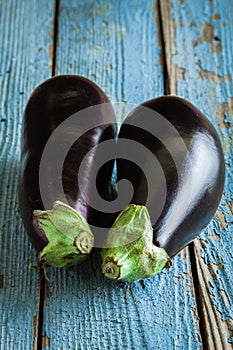 Two raw organic eggplant on old wooden background