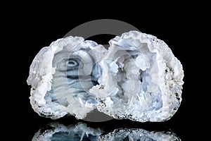 Two raw quartz druse or geode mineral stone in front of black background