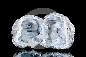 Two raw quartz druse or geode mineral stone in front of black background photo