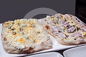 two raw Roman Pizza al taglio with egg and cheese and ham photo