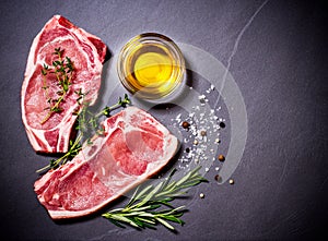 Two raw veal chops with ingredients