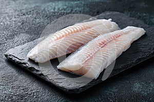 Fresh Raw Fish Fillets on Dark Slate