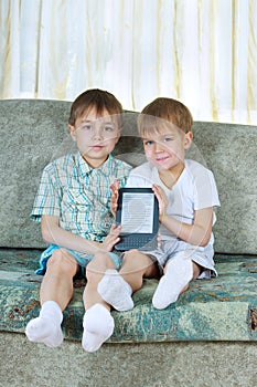 Two reading boys. With electronic book