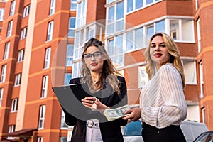Two real estate agents check new apartments before sale