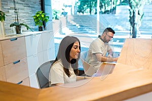 Two receptionists working in entrance of spa center