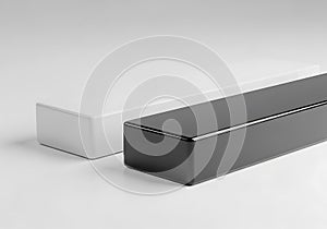 Two rectangular blocks one white and one black on a plain surface