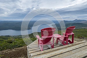 Two Red Adirondack Chairs With a Grand Vista #2