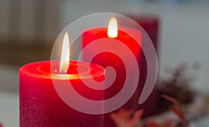 Two red advent candles are buring brightly on a modern advent wreath. photo