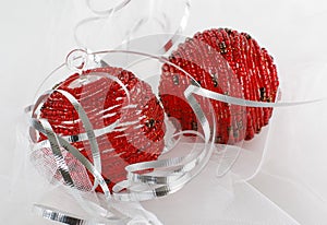 Two red beaded christmas ornaments with silver ribbon