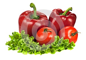 Two red bell peppers with two tomatoes on lettuce