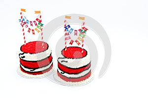 Two red birthday cakes with banners