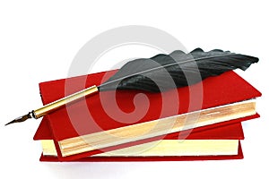Two red books and quill isolated on white