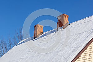 two red brick chimney on a roof
