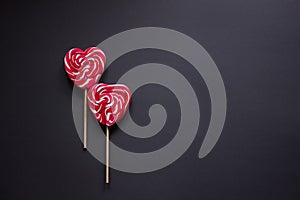 Two red candies on a stick in the shape of a heart