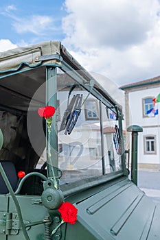 two red carnations decorating a military vehicle during the commemoration of April 25th in Portugal. Carnation Revolution photo