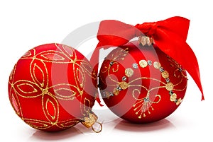 Two red christmas balls with ribbon isolated on a white