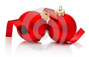 Two red Christmas baubles and curling paper Isolated on white background