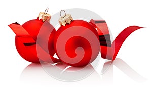 Two red Christmas baubles and curling paper Isolated on white background