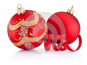 Two Red Christmas decoration baubles and curling paper isolated