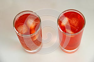 Two red cocktails with ice