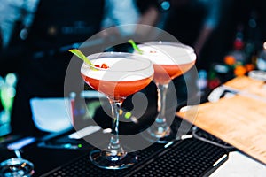 Two Red Colourful cocktails served in nightclub