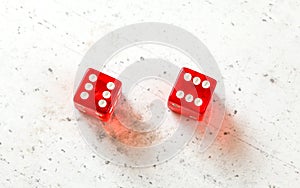 Two red craps dices showing Boxcars or Midnight double number six overhead shot on white board