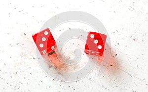 Two red craps dices showing Hard Six double number three overhead shot on white board