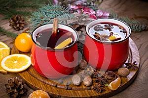 Two red cups with mulled wine on festive table