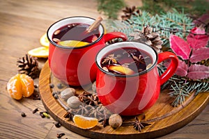 Two red cups with mulled wine on festive table