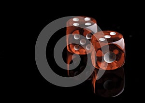 Two red dice on black background